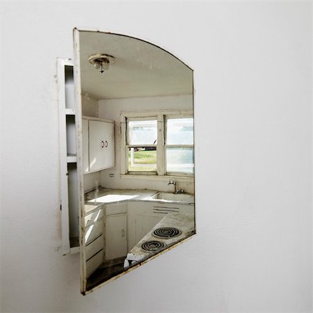 Reflection of empty abandoned dirty kitchen in mirror. Stock Photo - Budget Royalty-Free & Subscription, Code: 400-04463395