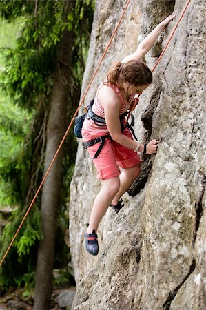 simsearch:400-04949609,k - A female climber, climbing using a top rope on a steep rock face (crag).  A shallow depth of field has been used to isolated the climber, with the focus on the head and right hand. Stock Photo - Budget Royalty-Free & Subscription, Code: 400-04463867