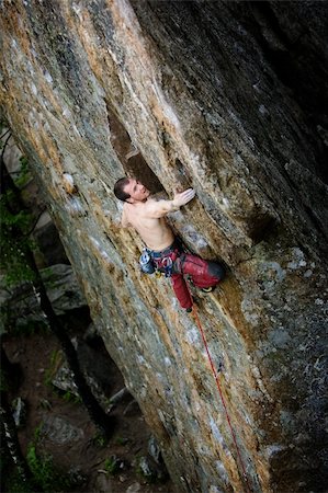 simsearch:400-04463866,k - A male climber, viewed from above, climbs a very high and steep crag. Stockbilder - Microstock & Abonnement, Bildnummer: 400-04463874