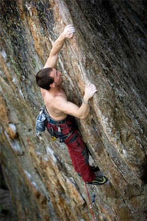 simsearch:400-03936239,k - A male climber, viewed from above, climbs a very high and steep crag. Stockbilder - Microstock & Abonnement, Bildnummer: 400-04463875