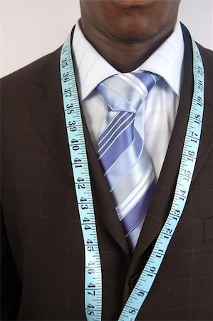 This is an image of a black business man, wearing measuring tape. Foto de stock - Royalty-Free Super Valor e Assinatura, Número: 400-04474184