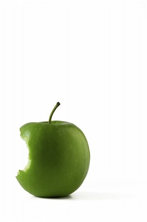 simsearch:400-04994957,k - Isolated green apple with a bite taken from it located in bottom left hand corner with plenty of space to add text. Fotografie stock - Microstock e Abbonamento, Codice: 400-04474786