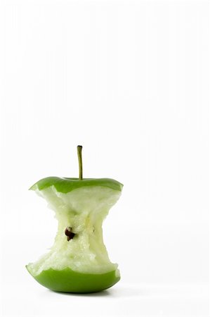 simsearch:400-06457388,k - Isolated fresh green apple eaten to the core located in the bottom left with room for text to be added. Photographie de stock - Aubaine LD & Abonnement, Code: 400-04474787