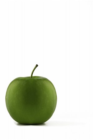 simsearch:400-06457388,k - Isolated green apple with a bite taken from it located in bottom left hand corner with plenty of space to add text. Photographie de stock - Aubaine LD & Abonnement, Code: 400-04474788