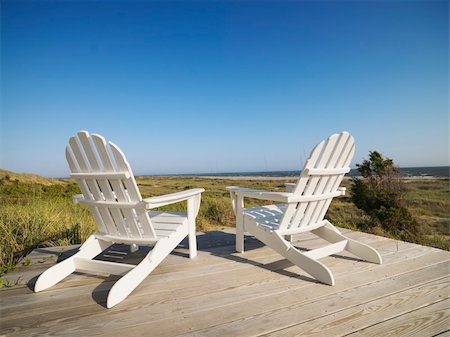 simsearch:400-03923118,k - Two adirondack chairs on wooden deck overlooking beach at Bald Head Island, North Carolina. Fotografie stock - Microstock e Abbonamento, Codice: 400-04475170
