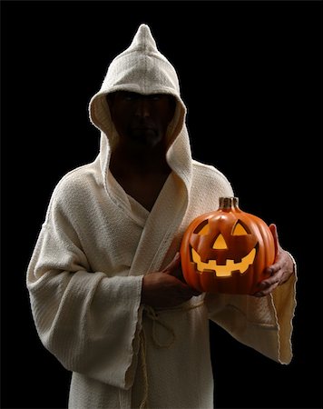 simsearch:400-04540383,k - Hooded man holding jack-o-lantern isolated over a black background Stock Photo - Budget Royalty-Free & Subscription, Code: 400-04475328