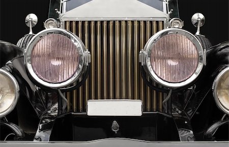 restoring cars - The grill and headlamps of an expensive antique classic car.  Slightly desaturated for more retro feel.  The pinkish tints in the headlight glass are normal and not added/altered. Stock Photo - Budget Royalty-Free & Subscription, Code: 400-04475643