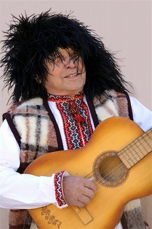 elderly person singing - An old man in traditional ukranian clothes playing guitar Stock Photo - Budget Royalty-Free & Subscription, Code: 400-04475670
