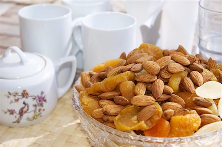 family eating light - Almonds, dried apricots and pineapples in a vase. Chinese porcelain tea set. Energizing breakfast for a new day. Stock Photo - Budget Royalty-Free & Subscription, Code: 400-04475954