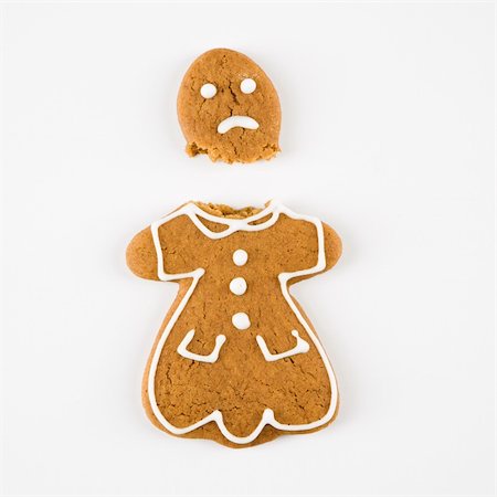 Frowning female gingerbread cookie broken in half. Stock Photo - Budget Royalty-Free & Subscription, Code: 400-04476012