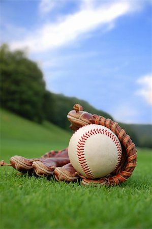 Close up of a well worn baseball glove on the grass Stock Photo - Budget Royalty-Free & Subscription, Code: 400-04477655