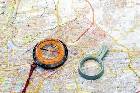 a compass and a handglass lying on a map - close up Stock Photo - Budget Royalty-Free & Subscription, Code: 400-04477681