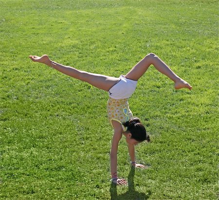 Teen girl doing a handstand on a grass Stock Photo - Budget Royalty-Free & Subscription, Code: 400-04477920
