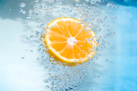 Tangerine slice in blue   water with air bubble. Stock Photo - Budget Royalty-Free & Subscription, Code: 400-04479575