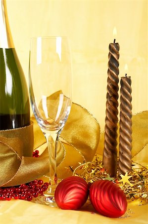 simsearch:400-05082002,k - Christmas decoration with champagne bottle, empty glass and candles, over yellow background. Shallow DOF Photographie de stock - Aubaine LD & Abonnement, Code: 400-04479891