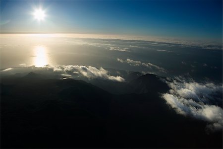 simsearch:400-04006465,k - Aerial view of Maui, Hawaii coast with sun over Pacific ocean and mountainous landscape. Stock Photo - Budget Royalty-Free & Subscription, Code: 400-04470869