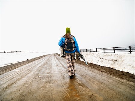 snowboarder (female) - Young woman in winter clothes walking down muddy dirt road holding snowboard and boots. Stock Photo - Budget Royalty-Free & Subscription, Code: 400-04471049