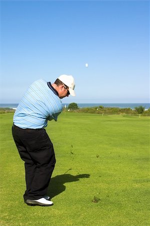 simsearch:400-05370464,k - Golfer hitting the ball to the green. Ball in motion in the sky. Stock Photo - Budget Royalty-Free & Subscription, Code: 400-04473706
