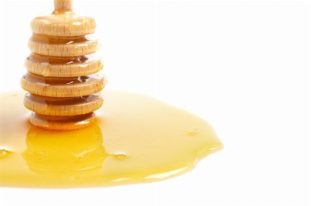 simsearch:400-04865454,k - Honey and wooden drizzler, reflected on white background. Shallow DOF Stockbilder - Microstock & Abonnement, Bildnummer: 400-04484095