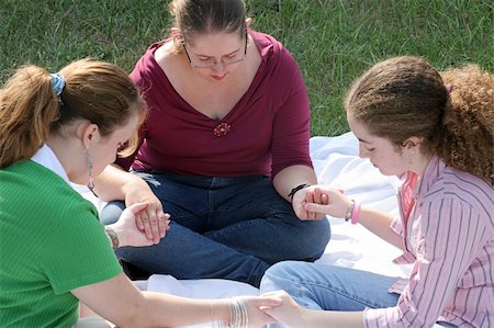 A group of teen girls having a prayer circle outdoors. Stock Photo - Budget Royalty-Free & Subscription, Code: 400-04484161