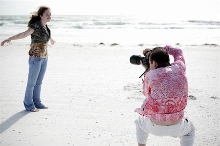 A photographer working with a model to get the right pose. Shallow depth of field with focus on photographer's head. Photographie de stock - Aubaine LD & Abonnement, Code: 400-04484735