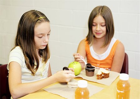 eating in the classroom - Two school girls eating lunch together in the cafeteria. Stock Photo - Budget Royalty-Free & Subscription, Code: 400-04484751