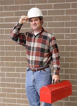 A handsome construction worker carrying his toolbox and tipping his hard hat. Photographie de stock - Aubaine LD & Abonnement, Code: 400-04485119