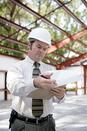 simsearch:400-04485397,k - A building inspector on site reviewing his notes.  Vertical view. Stock Photo - Budget Royalty-Free & Subscription, Code: 400-04485152