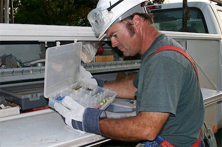 An electrician looking through tools on his service truck. Stock Photo - Budget Royalty-Free & Subscription, Code: 400-04485183