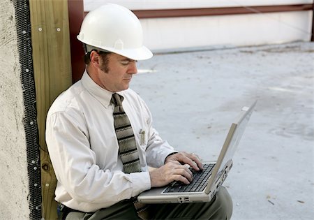 An engineer on a construction site using a laptop computer. Stock Photo - Budget Royalty-Free & Subscription, Code: 400-04485200