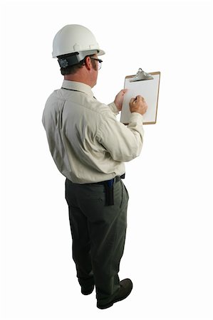 A construction safety inspector marking his checklist - full, over-the-shoulder view Stock Photo - Budget Royalty-Free & Subscription, Code: 400-04485257
