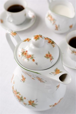 simsearch:400-04625122,k - Coffee or tea set on the table - teapot on the front (focus on the top of it) cups and milk jug behind. Shallow DOF. Foto de stock - Super Valor sin royalties y Suscripción, Código: 400-04485376