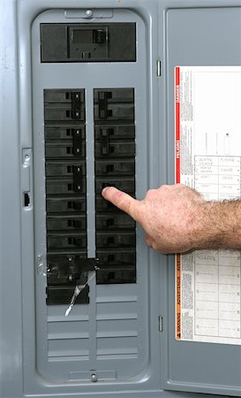 A closeup of an electrical panel with an electrician turning off the breaker so he can work safely according to OSHA standards. Photographie de stock - Aubaine LD & Abonnement, Code: 400-04485386