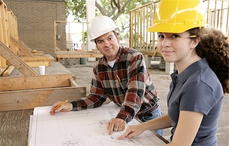 simsearch:400-04485437,k - A construction foreman going over the blueprints with a female apprentice. Stock Photo - Budget Royalty-Free & Subscription, Code: 400-04485409