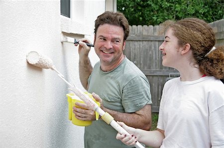 simsearch:400-04349276,k - A father and daughter laughing and smiling as they paint the house together. Stock Photo - Budget Royalty-Free & Subscription, Code: 400-04485400