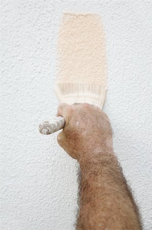 A house painter's hand, speckled with paint, holding a brush and painting on a house. Stock Photo - Budget Royalty-Free & Subscription, Code: 400-04485420
