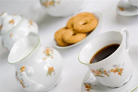 simsearch:600-06967760,k - Coffee (or tea) set on the table - cup of coffee on the front (focus on it) cookies, milk jug and sugar bowl behind. Shallow depth of field. Stock Photo - Budget Royalty-Free & Subscription, Code: 400-04485451