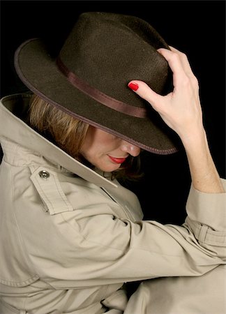 A beautiful, mysterious woman in a trenchcoat and fedora hat, turned away so her face is hidden. Stock Photo - Budget Royalty-Free & Subscription, Code: 400-04485695