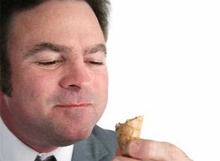 excited ice cream - A closeup of a businessman eating an ice cream cone and smiling with his mouth full. Isolated with room for text. Stock Photo - Budget Royalty-Free & Subscription, Code: 400-04486177