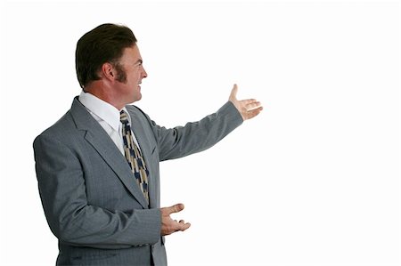 simsearch:400-04486166,k - A businessman in a gray suit gesturing toward a chart or graph. Isolated. Stockbilder - Microstock & Abonnement, Bildnummer: 400-04486171