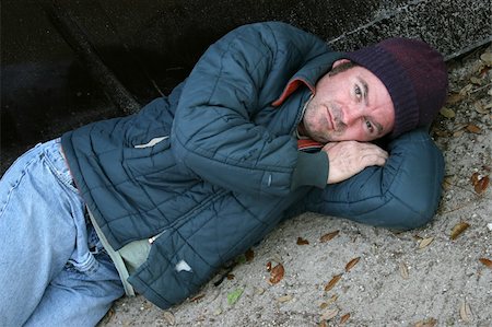 A homeless man lying on the ground. Foto de stock - Super Valor sin royalties y Suscripción, Código: 400-04486188