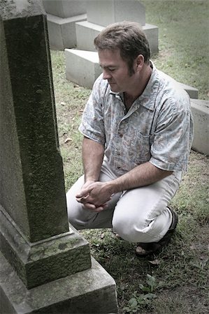 simsearch:614-06719568,k - a man in a graveyard with hands folded in reverence - partly desaturated Foto de stock - Royalty-Free Super Valor e Assinatura, Número: 400-04486181