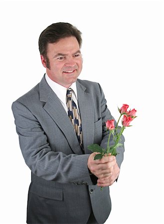 simsearch:400-04486211,k - A handsome man in a suit bringing roses for his date. Stockbilder - Microstock & Abonnement, Bildnummer: 400-04486210