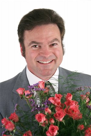 simsearch:400-04486211,k - A headshot of a handsome businessman holding a bouquet of roses for his wife, girlfriend, secretary. Stockbilder - Microstock & Abonnement, Bildnummer: 400-04486211