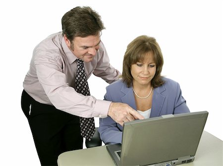 A male colleague offering a suggestion to a female coworker.  Isolated on white. Stock Photo - Budget Royalty-Free & Subscription, Code: 400-04486260