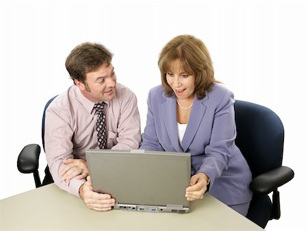 A male-female business team.  He is showing her something surprising on his laptop. Photographie de stock - Aubaine LD & Abonnement, Code: 400-04486262