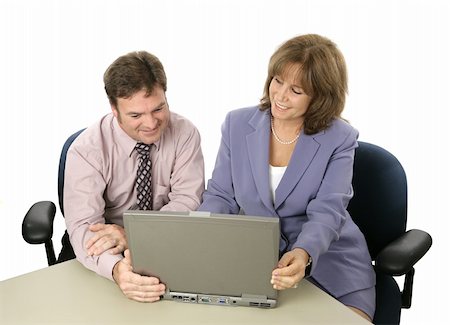 A male and female business colleague working on a project together using a laptop. Or a professional showing something on the computer to a client. Photographie de stock - Aubaine LD & Abonnement, Code: 400-04486263