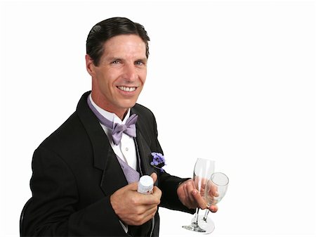 A handsome man in a tuxedo with a champagne bottle and two glasses. Photographie de stock - Aubaine LD & Abonnement, Code: 400-04486306