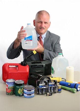 drinking can - a meteorologist with hurricane supplies, holding up a jug of water Stock Photo - Budget Royalty-Free & Subscription, Code: 400-04486302