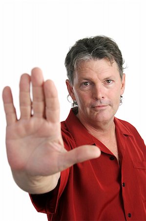 simsearch:400-03972352,k - A handsome, serious man holding his hand out in a stop gesture.  Focus on man's face. Isolated. Stock Photo - Budget Royalty-Free & Subscription, Code: 400-04486314